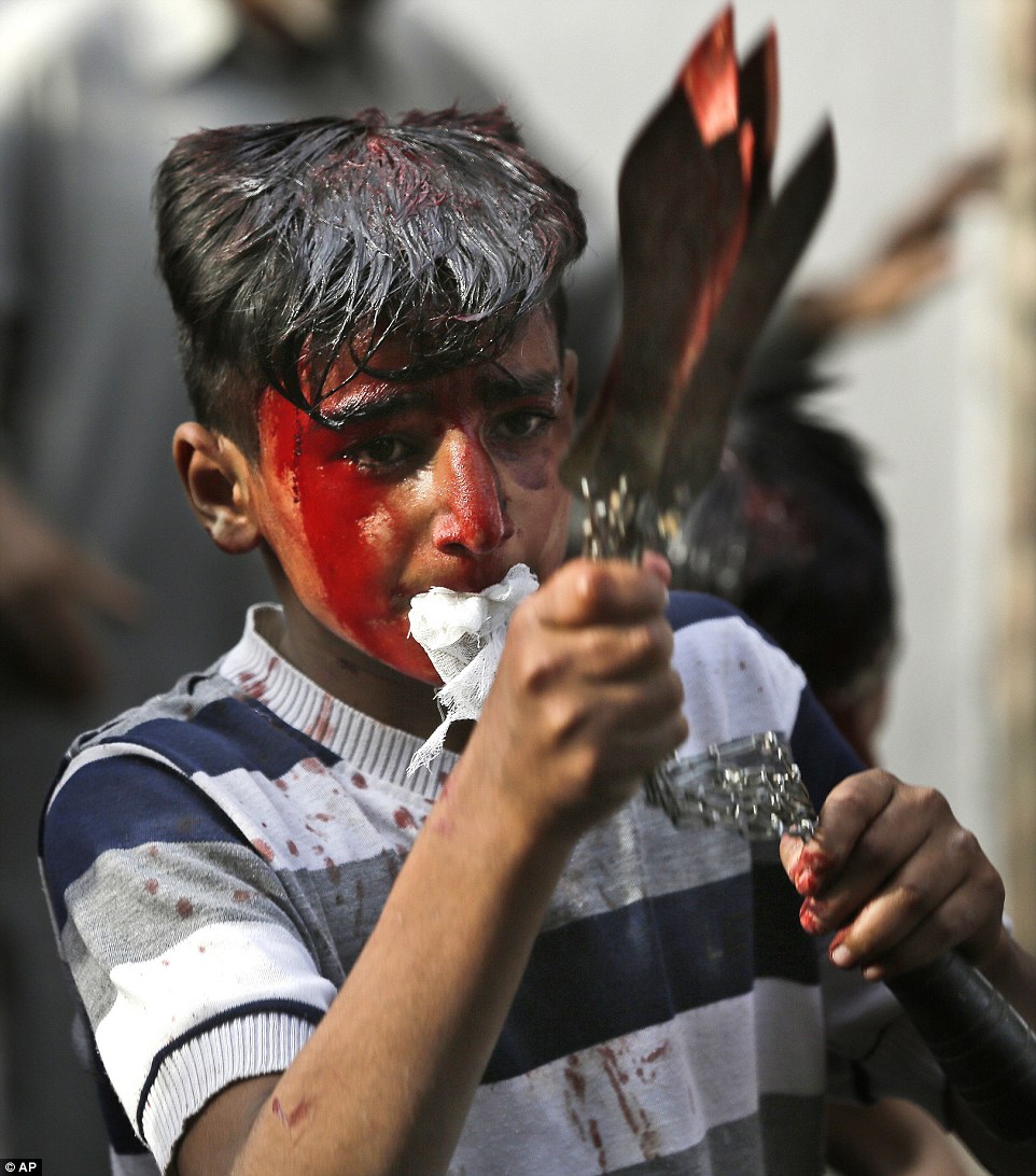 A Kashmiri Shia Muslim boy flagellates himself during a Muharram procession in Srinagar in Indian controlled Kashmir