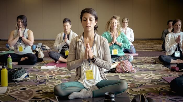 group of yoga students meditating